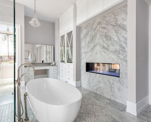 Luxurious Master Bathroom in New Home with Fireplace and Large B